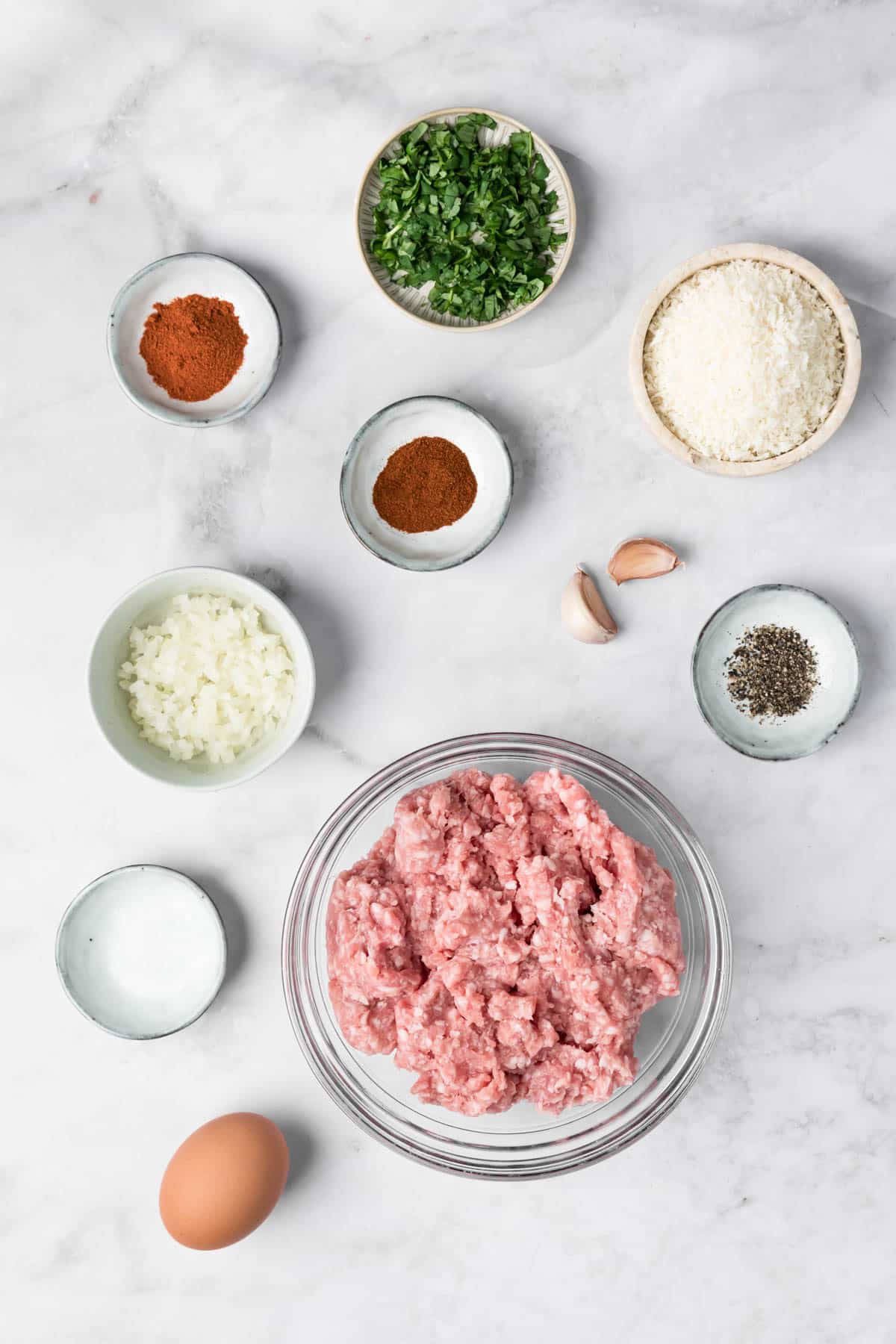 overhead view of the ingredients for spicy lamb meatballs in individual bowls.