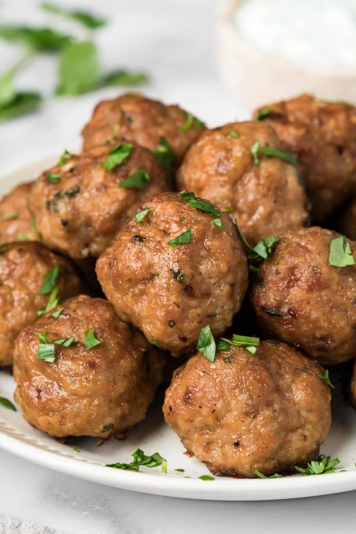 side view on a pile of spicy lamb meatballs on a plate.