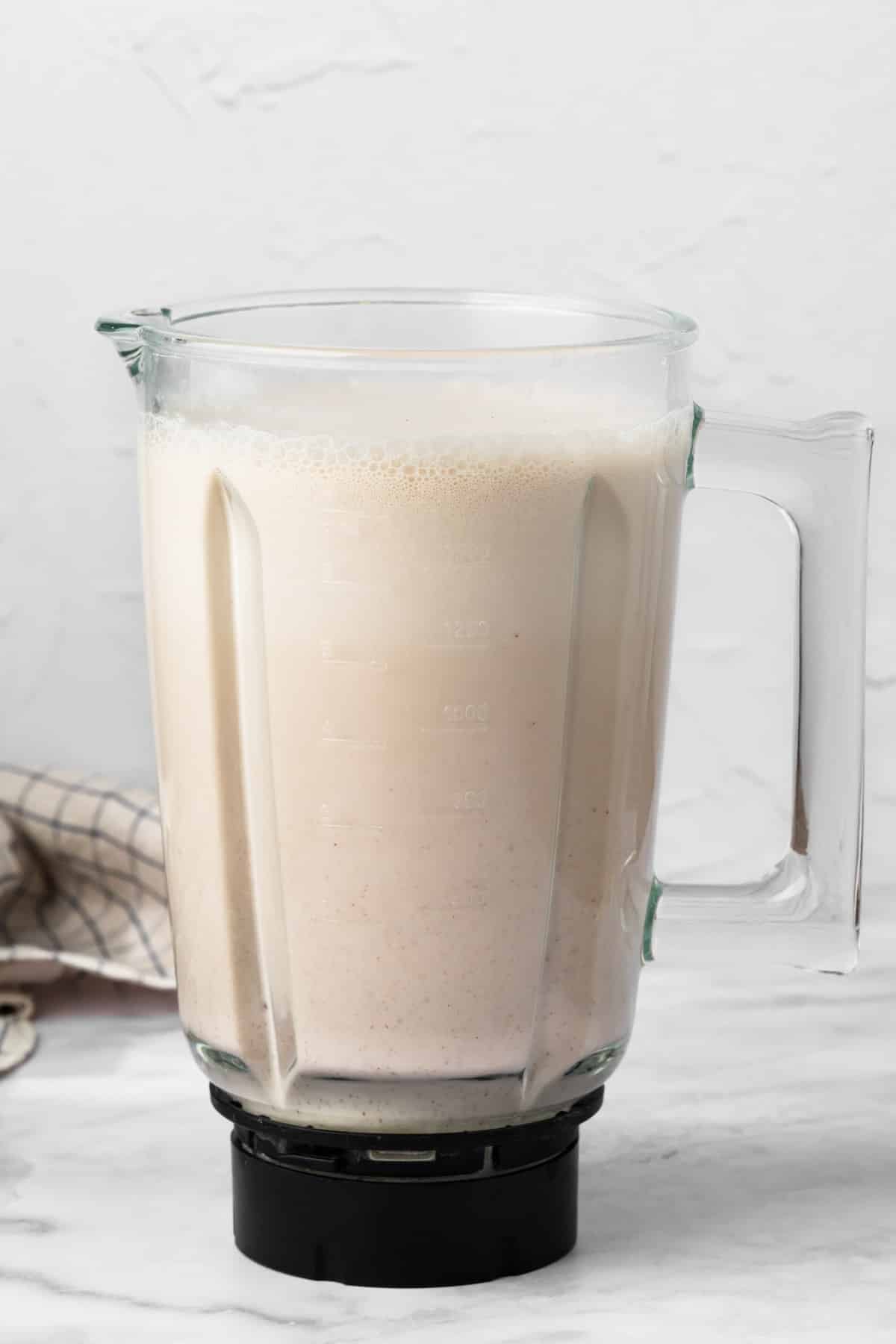 side view of blended horchata in a large blender.