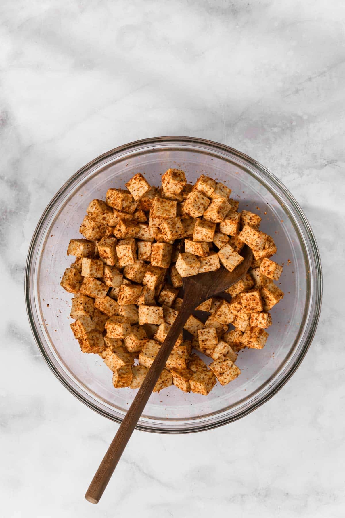 overhead view of taco-seasoned tofu in a glass bowl.