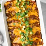 overhead view of tofu enchiladas in a baking dish.