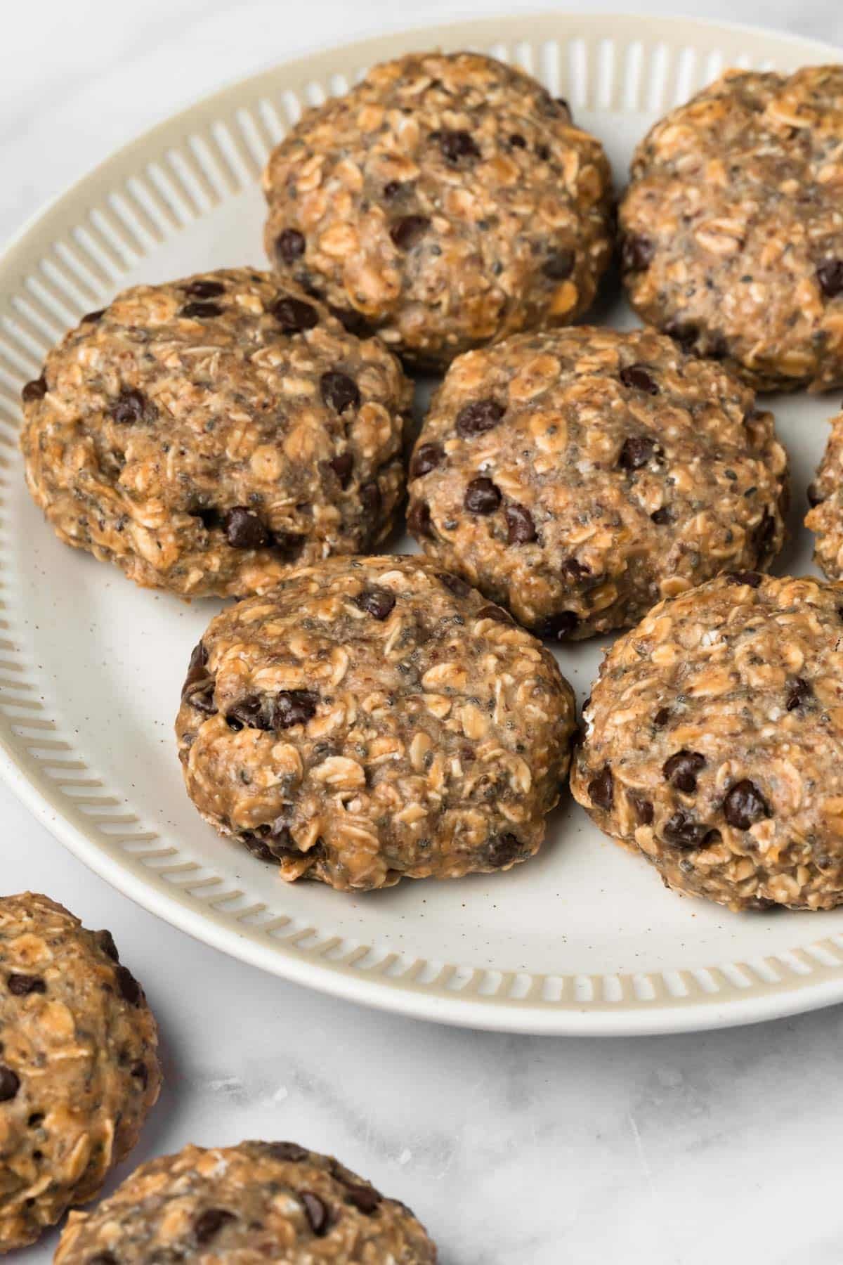 Side view of baked breakfast cookies on a white plate.