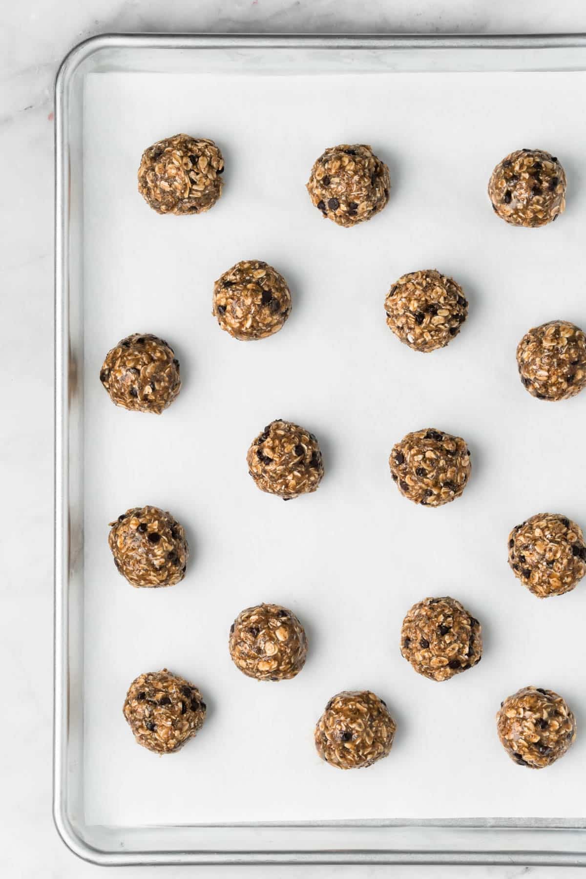 Overhead view of unbaked breakfast cookies on a baking sheet.