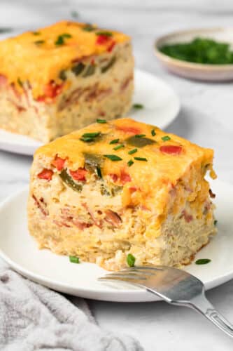 side view of a slice of crockpot breakfast casserole on a plate.