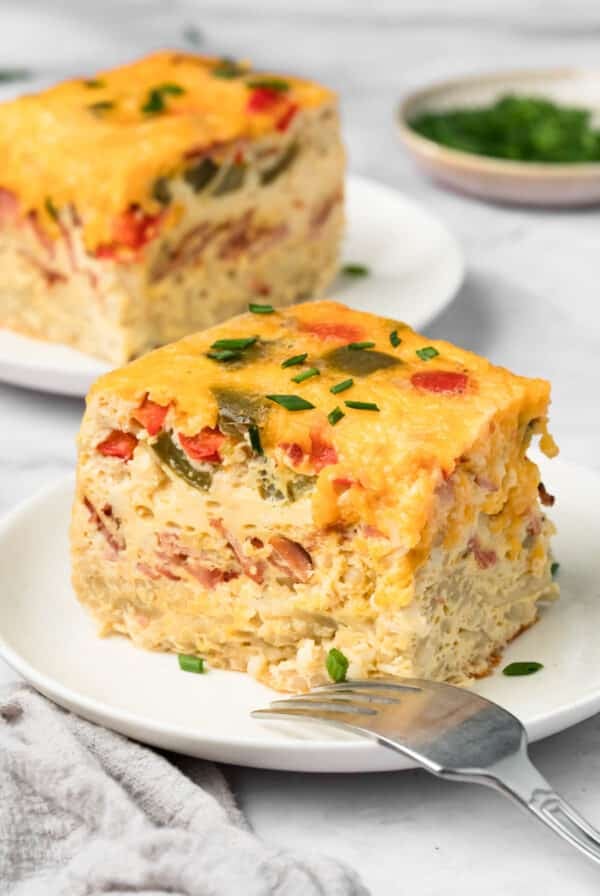 side view of a slice of crockpot breakfast casserole on a plate.