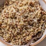 overhead view of cooked quinoa in a bowl with a fork.