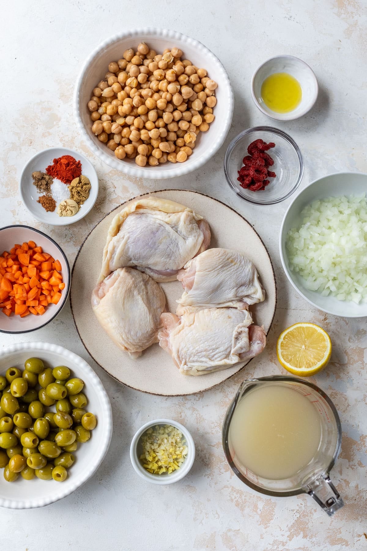 overhead view of the ingredients for Moroccan chicken in indiviual bowls.