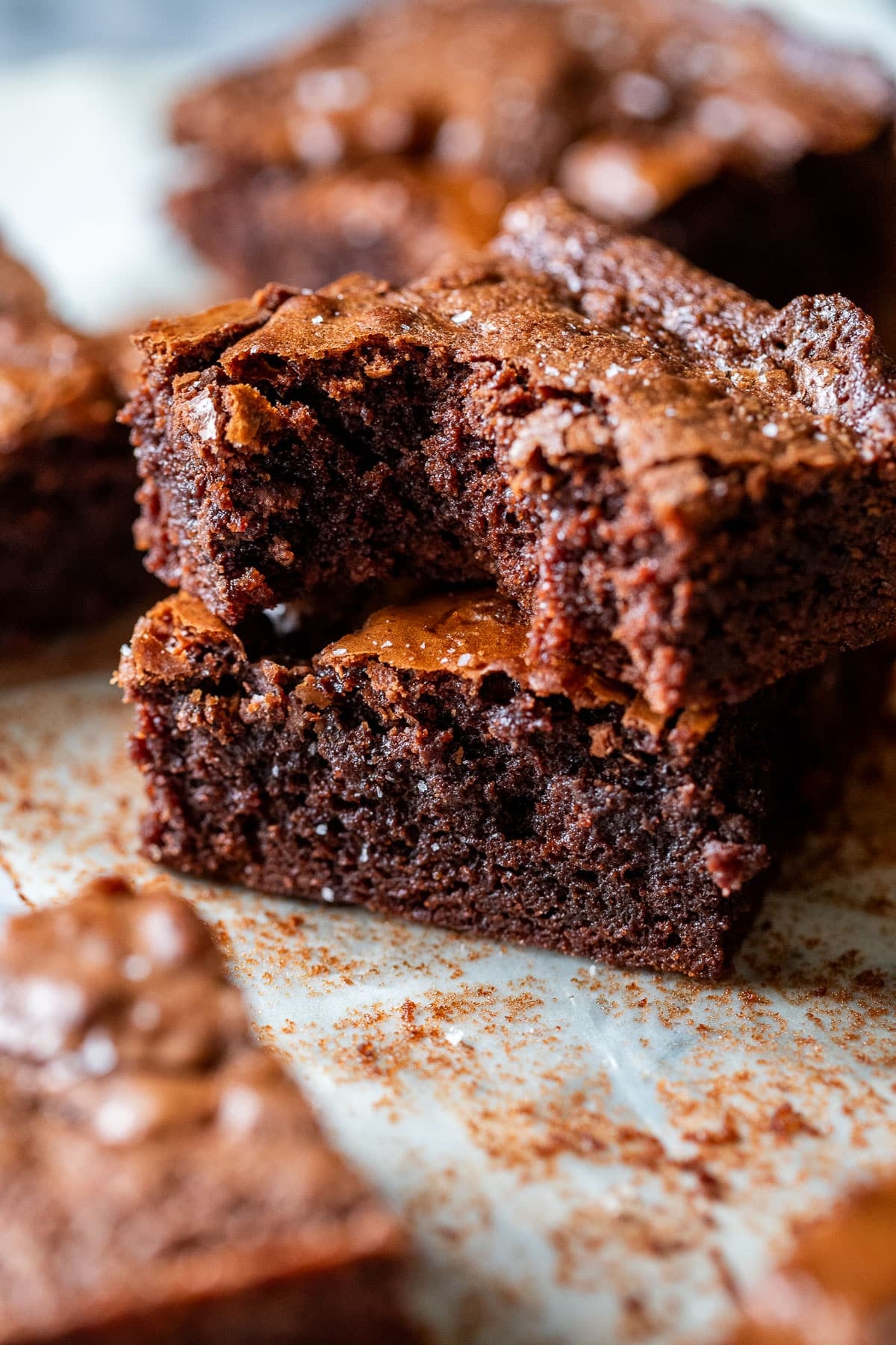 Close up onto two Nutella brownies stacked on top of each other with the top brownie missing a bite.