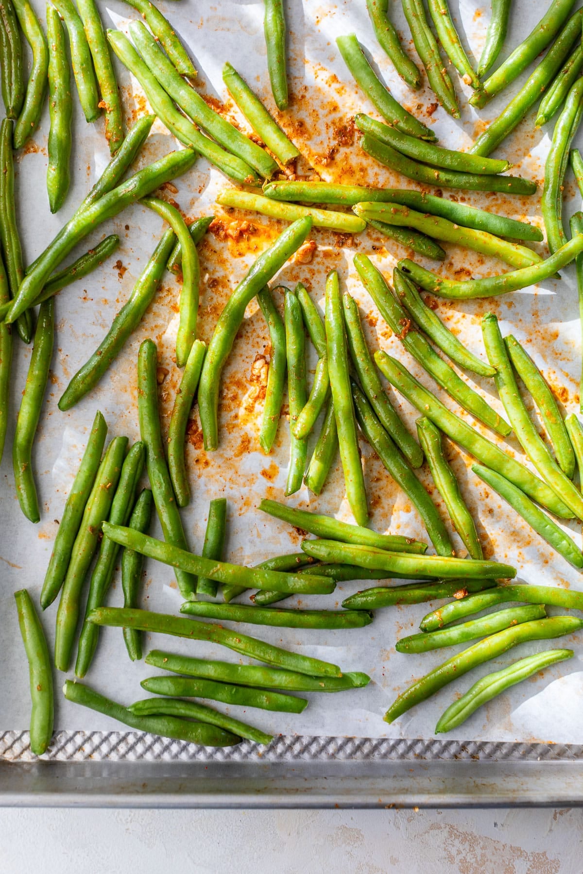 overhead view green beans on a sheet pan.