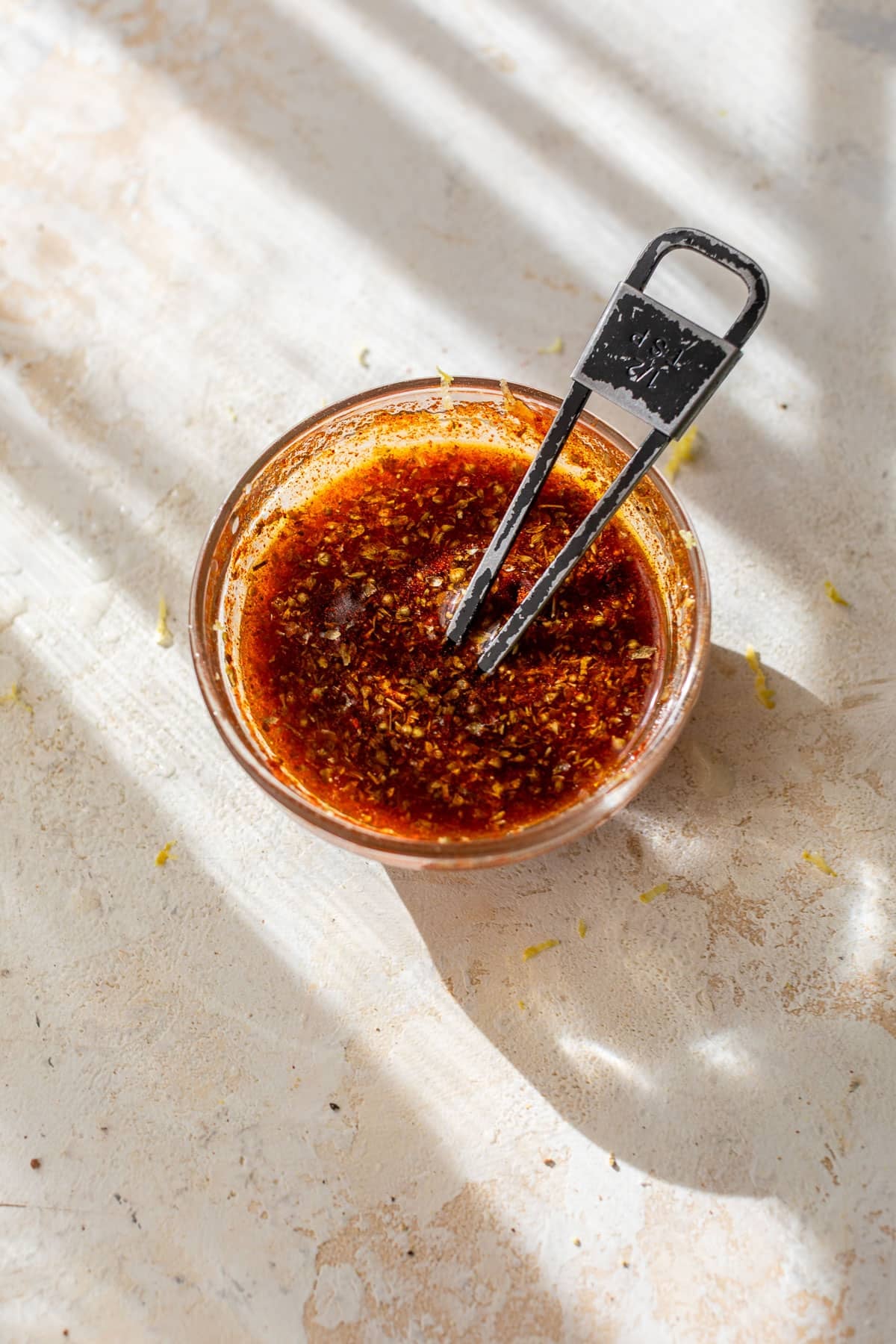 overhead view of a marinade for sheet pan salmon in a small bowl.