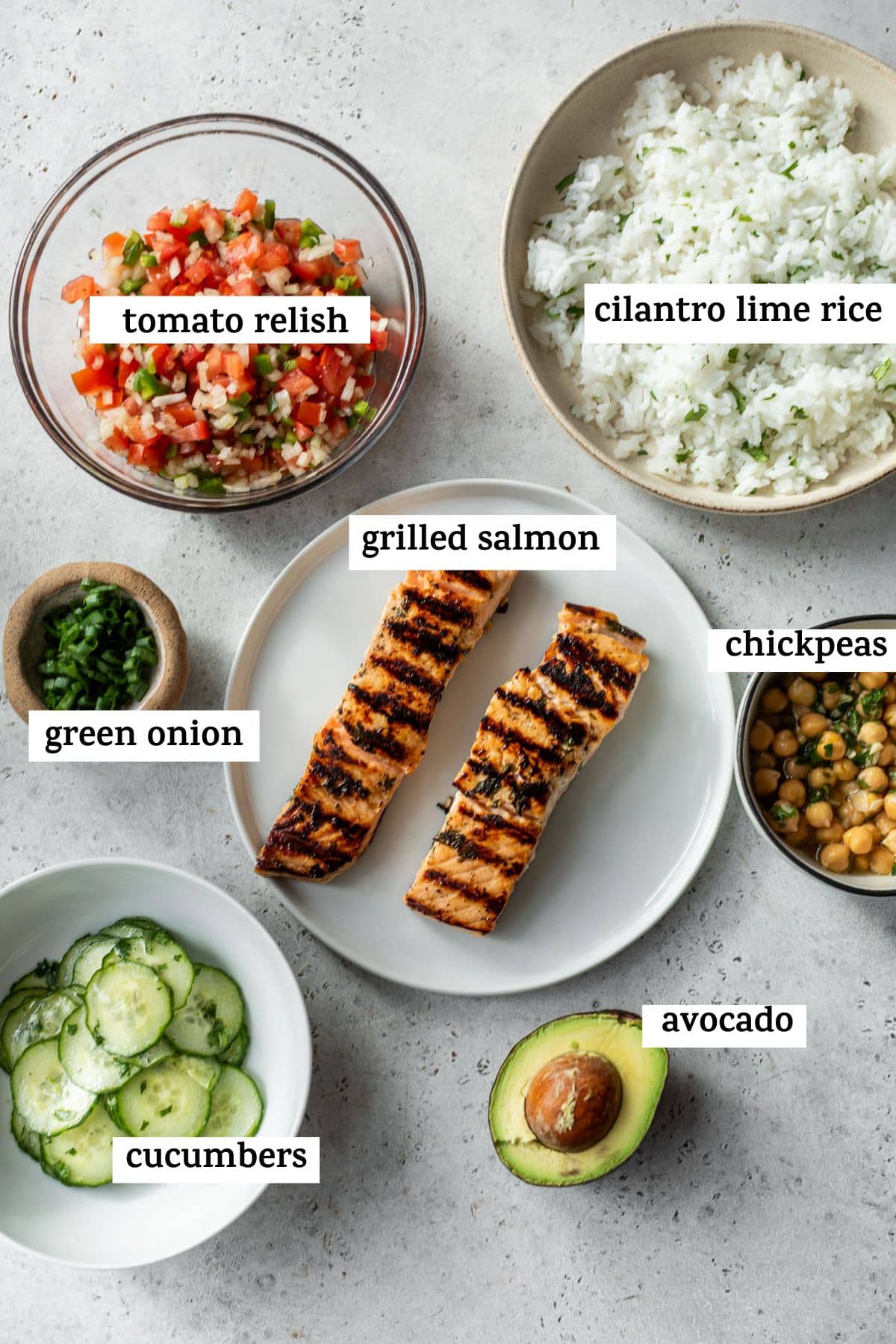 ingredients to make a salmon bowl, like salmon, tomato relish and cilantro lime rice