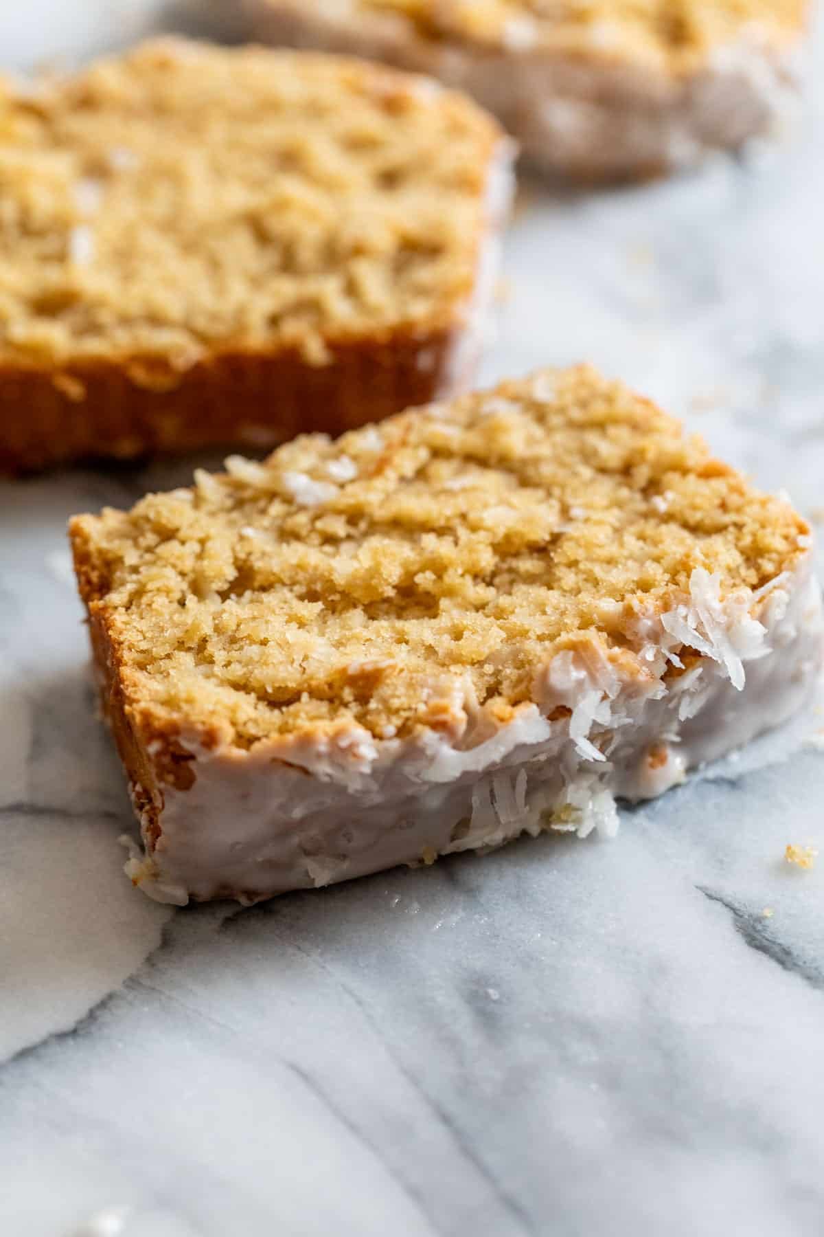 side view of a slice of baked sweet coconut bread.