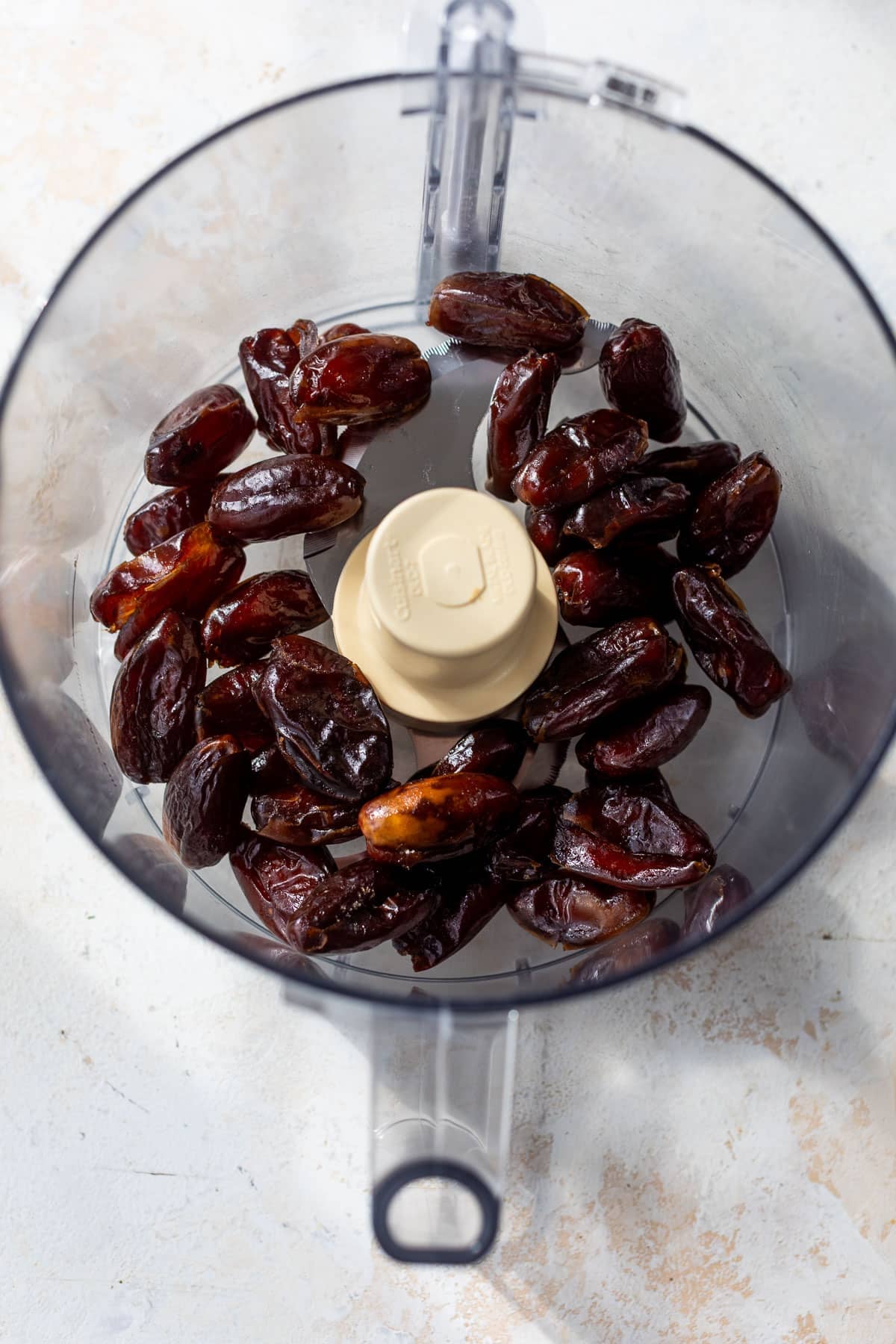overhead view of dates in a food processor.