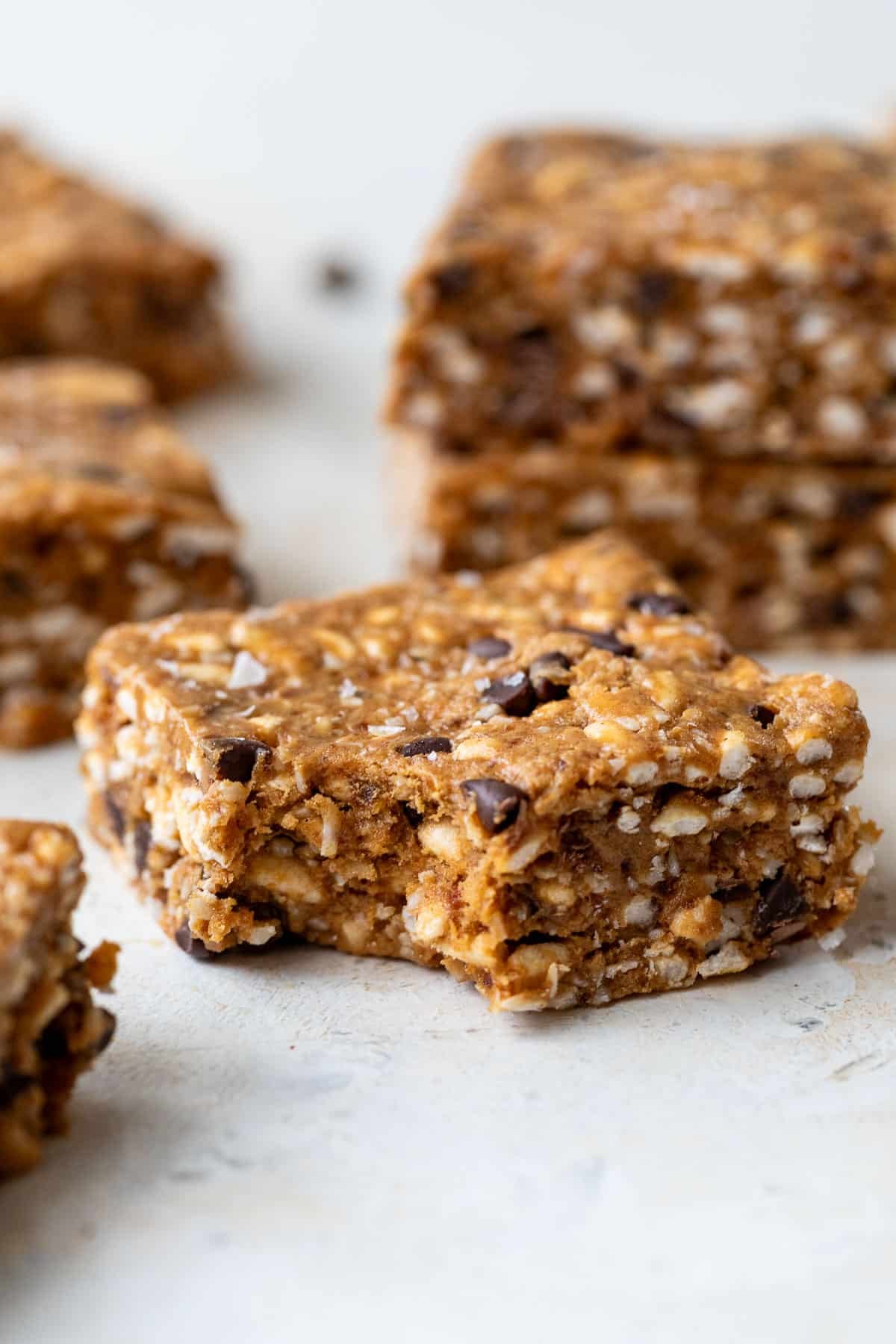 side view of a puffed rice protein bar with a bite missing.