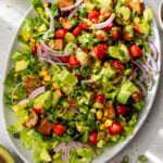 overhead view of a chicken taco salad on a white serving platter.
