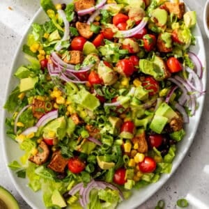 overhead view of a chicken taco salad on a white serving platter.
