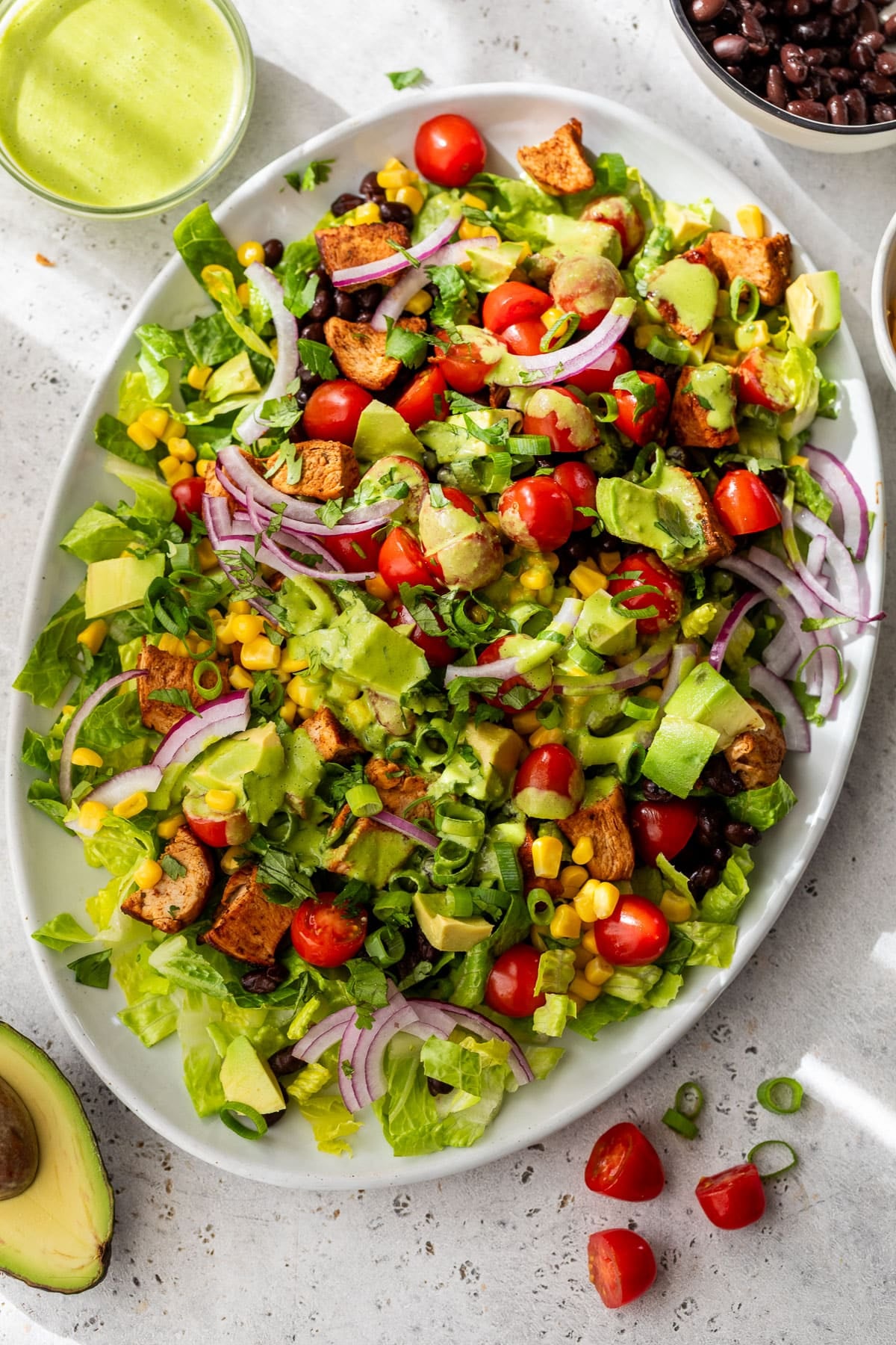 overhead view of a chicken taco salad on a white serving platter.