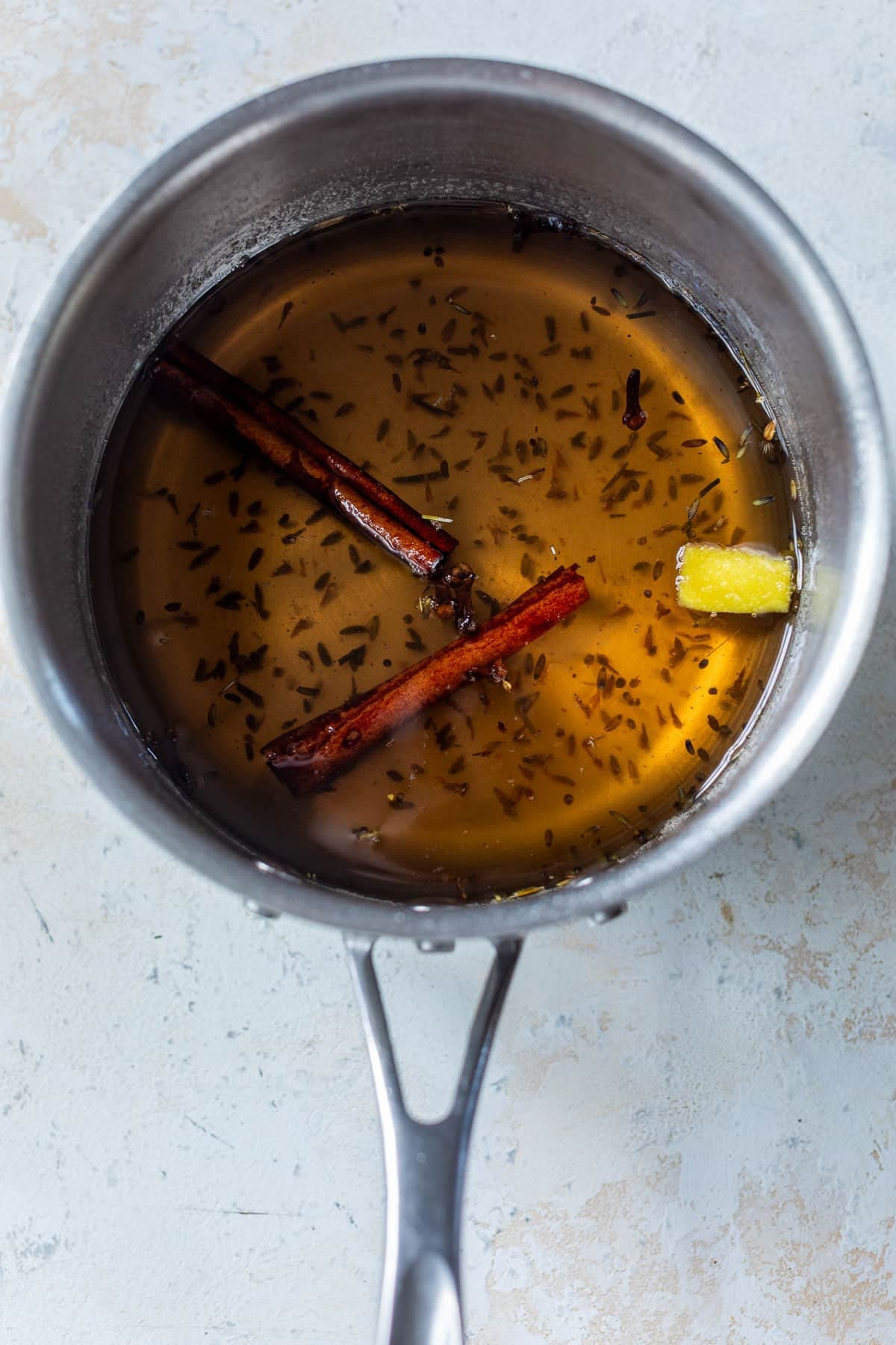 overhead view of the ingredients for lavender chai syrup in a saucepan.