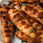 close up on a platter of grilled chicken tenders.