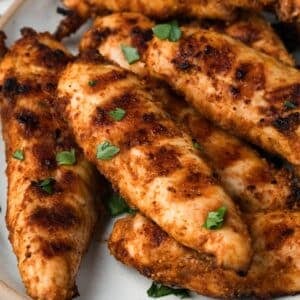 close up on a platter of grilled chicken tenders.