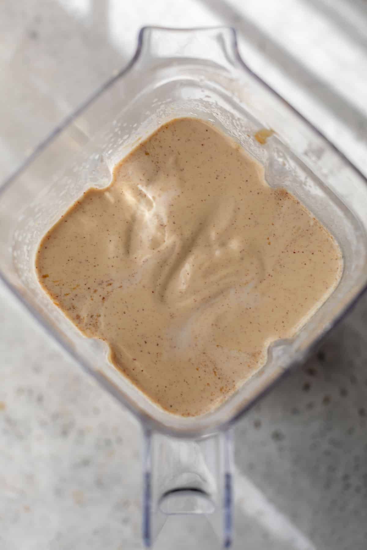 overhead view of the batter for peanut butter waffles in a blender.