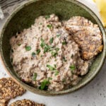 overhead view of a bowl of creamy sardine salad next to crackers.