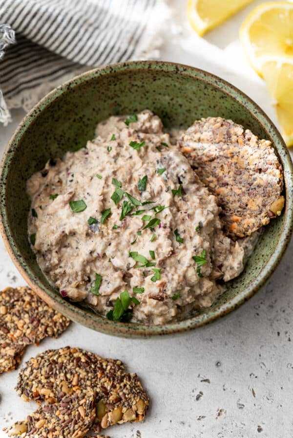overhead view of a bowl of creamy sardine salad next to crackers.