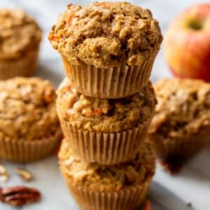 side view of a stack of 3 baked apple carrot muffins.
