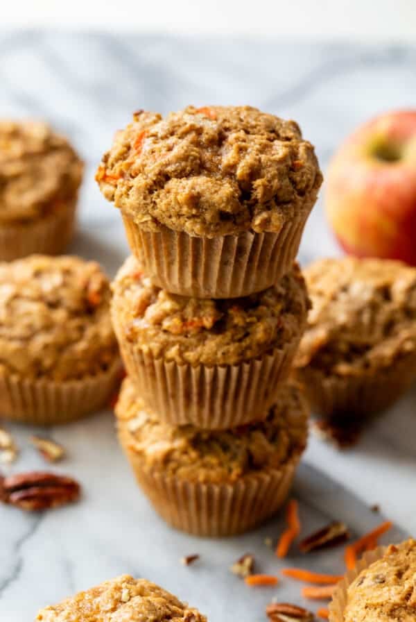 side view of a stack of 3 baked apple carrot muffins.