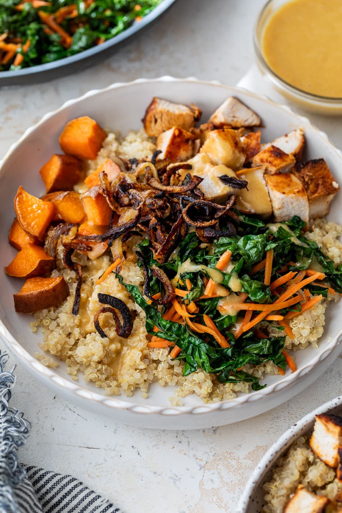 overhead view of a hot honey chicken bowl topped with blackened chicken and vegetables.