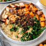 overhead view of a hot honey chicken bowl topped with blackened chicken and vegetables.