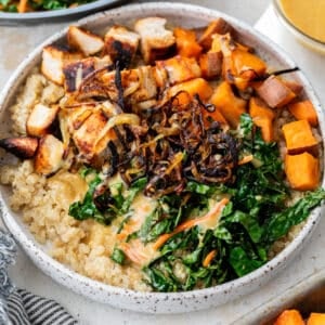 overhead view of a hot honey chicken bowl topped with blackened chicken and vegetables.