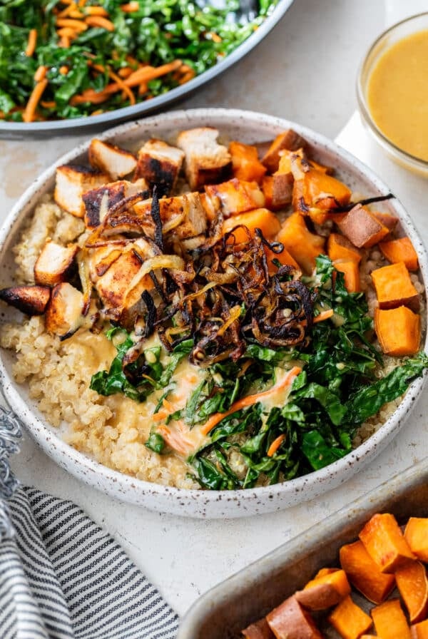 overhead view of a hot honey chicken bowl topped with blackened chicken and vegetables.