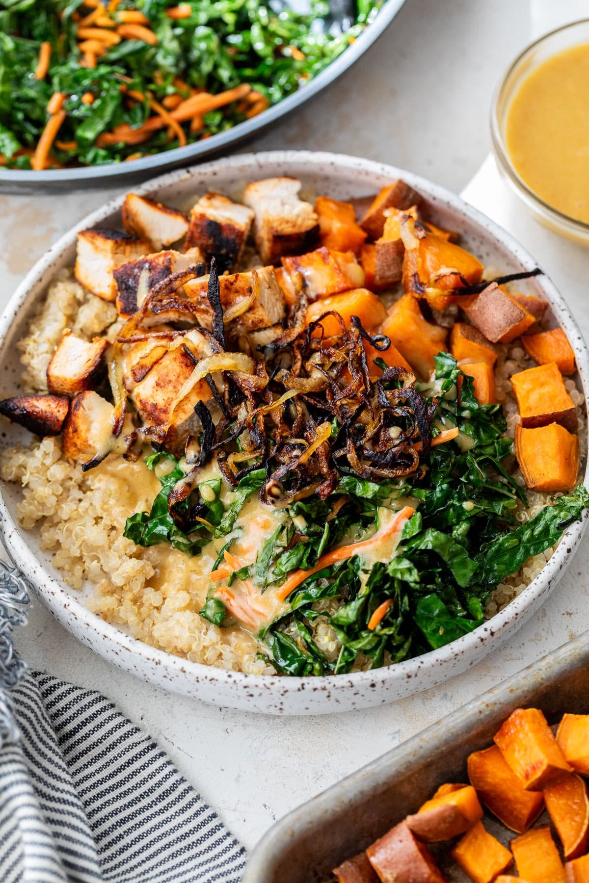 overhead view of a hot honey chicken bowl topped with blackened chicken and vegetables.