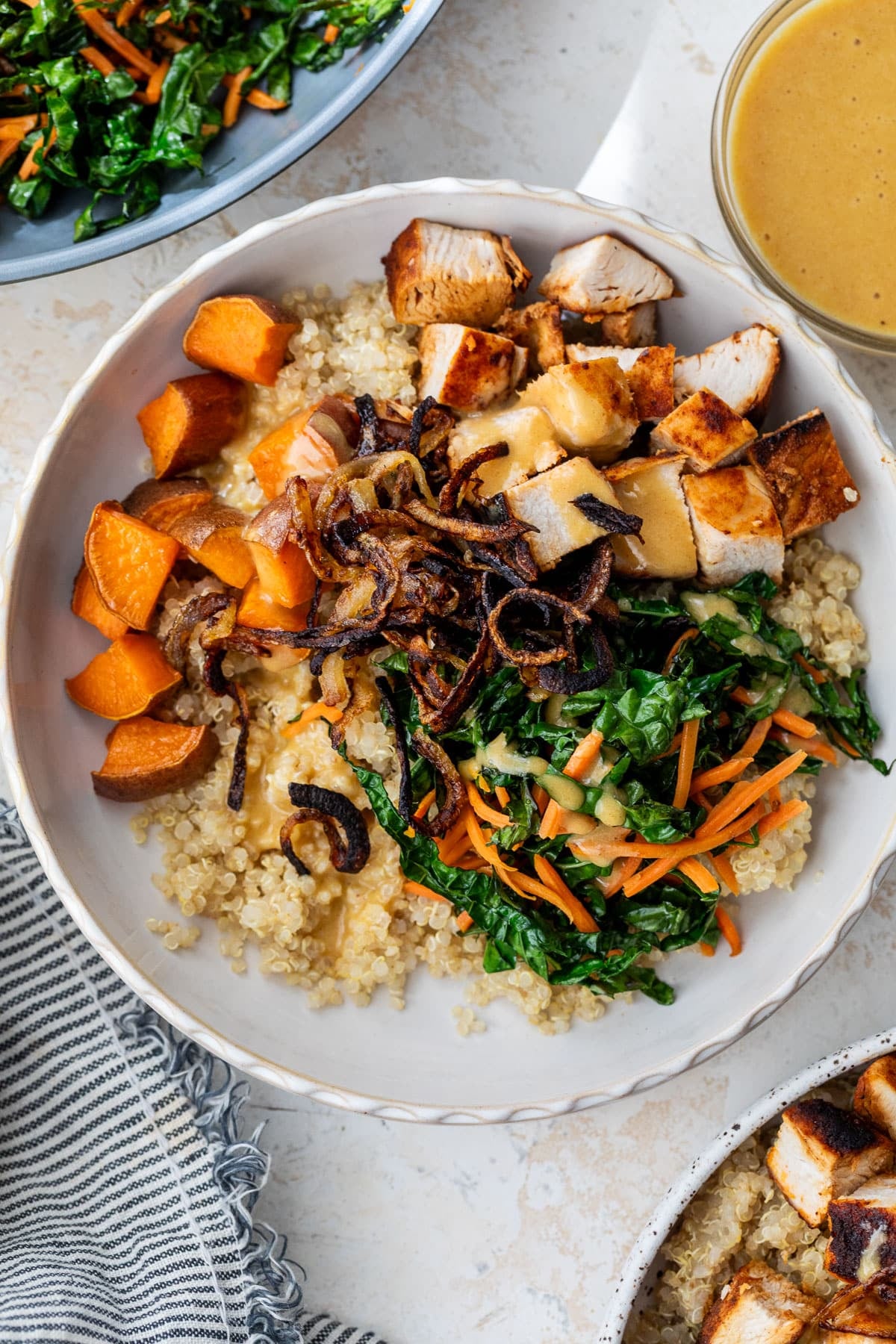 overhead view of a hot honey chicken bowl topped with blackened chicken and vegetables.