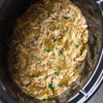 overhead view of shredded salsa verde chicken in a crockpot.
