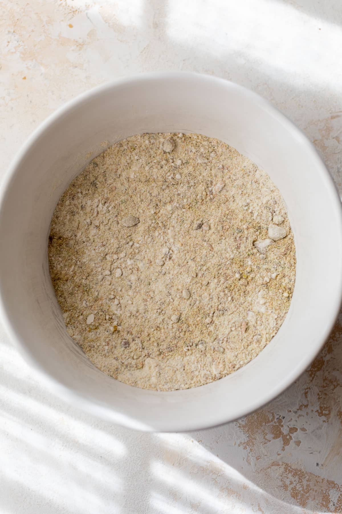 overhead view of the dry ingredients for pistachio cookies in a large bowl.