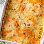 overhead view of baked scalloped sweet potatoes in a casserole dish.